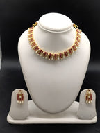 AD stone and freshwater pearl choker set with red American Diamond stones, pearl drops, and matching earrings