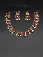 AD stone and freshwater pearl choker set with red American Diamond stones, pearl drops, and matching earrings