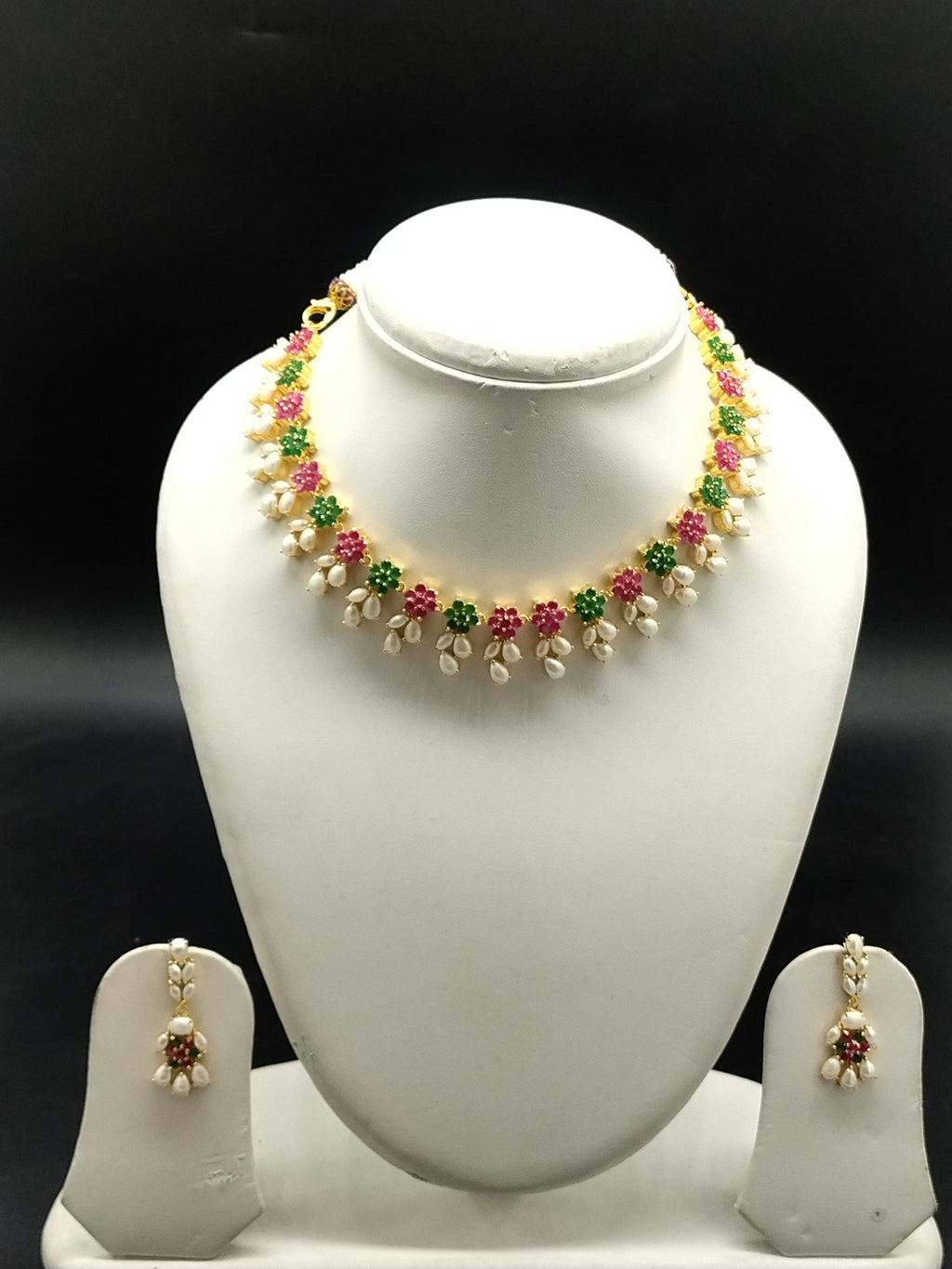 AD stone and freshwater pearl necklace set with red and green American Diamond stones, pearl drops, and matching earrings.