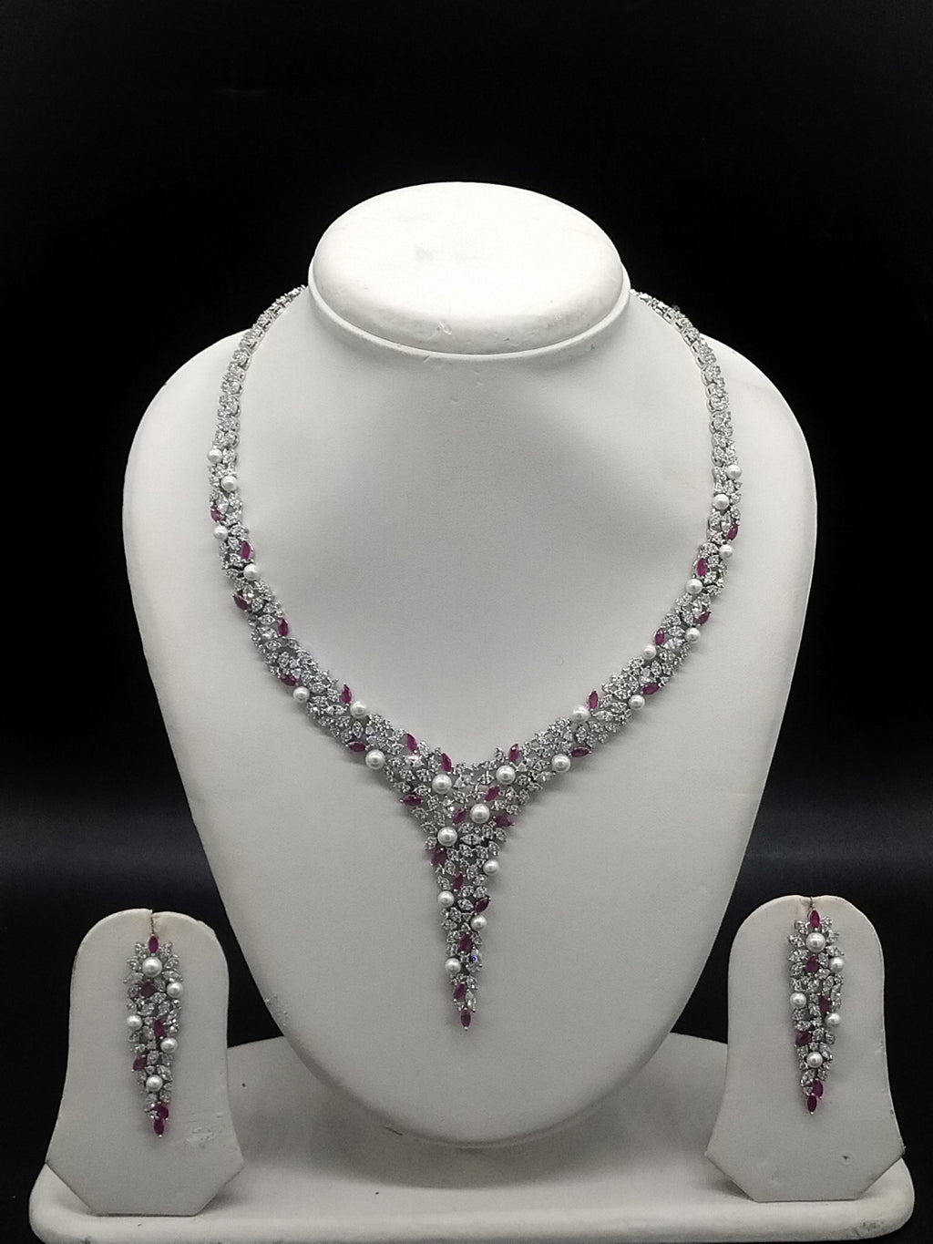 American diamond V shape necklace set with red stones and pearl accents for women