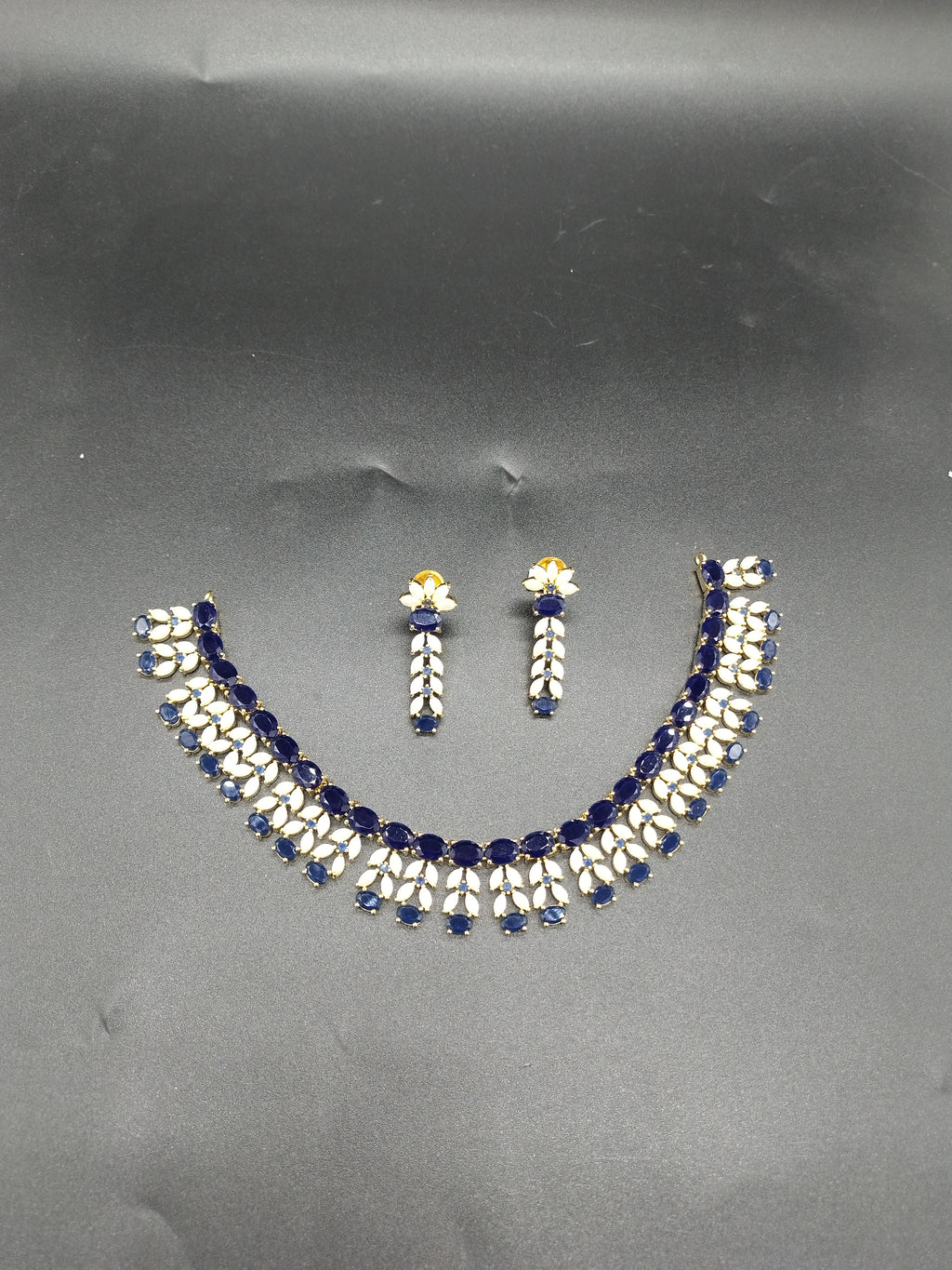 Blue AD stone and freshwater pearl choker set with dual-row design and matching stud earrings.