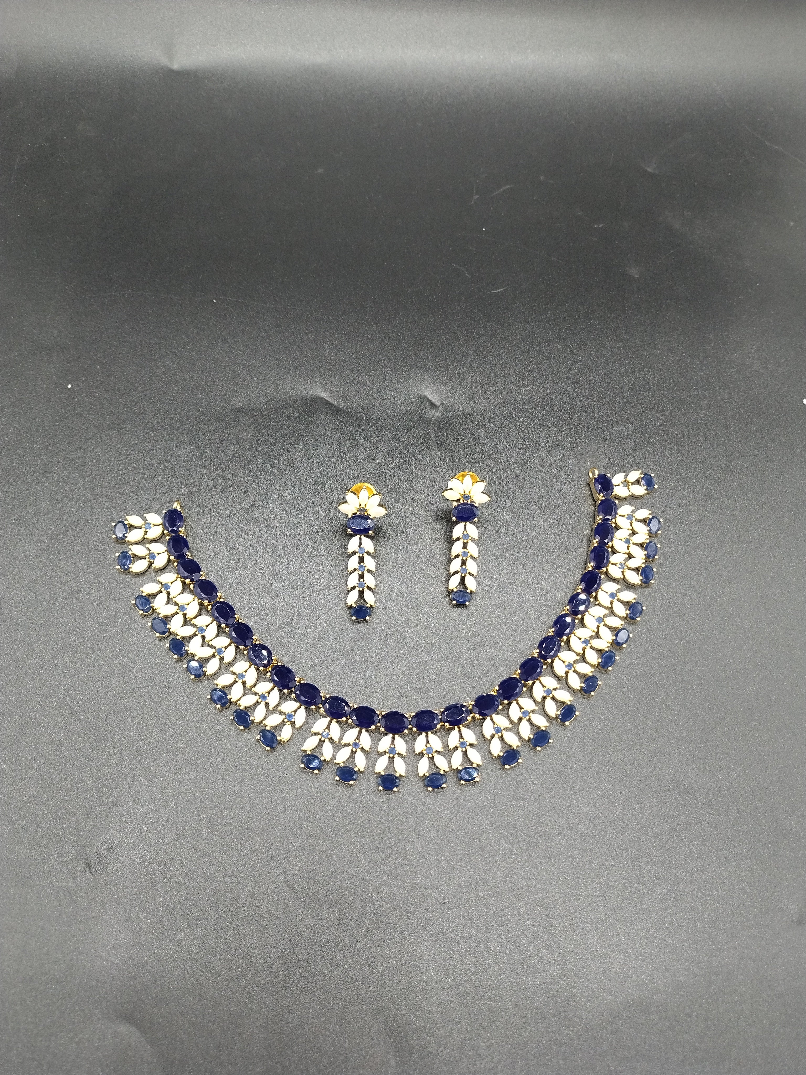 Blue AD stone and freshwater pearl choker set with dual-row design and matching stud earrings.