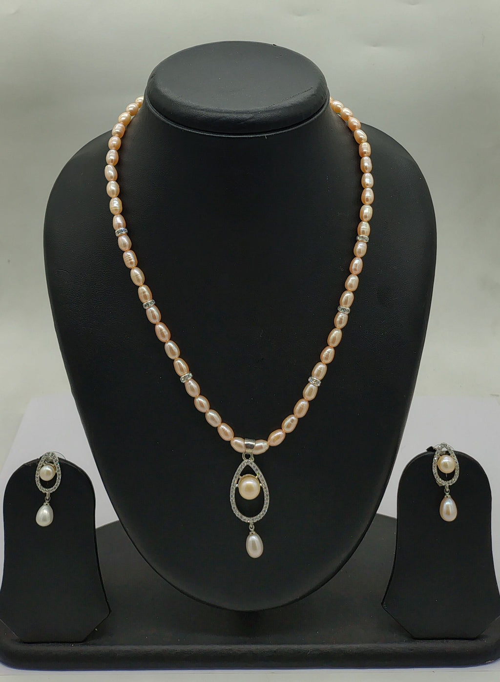One line freshwater pearl necklace and earrings set with teardrop pendant and blush-pink and ivory pearls