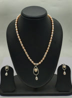 One line freshwater pearl necklace and earrings set with teardrop pendant and blush-pink and ivory pearls
