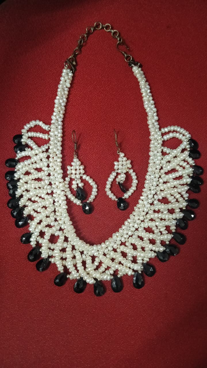 Buy black and white freshwater pearl bib necklace set with woven jali pattern and black teardrop beads