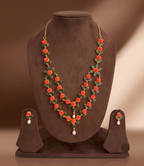 Coral Rose Elegance two line necklace set with hand-carved coral roses and freshwater pearl drops.