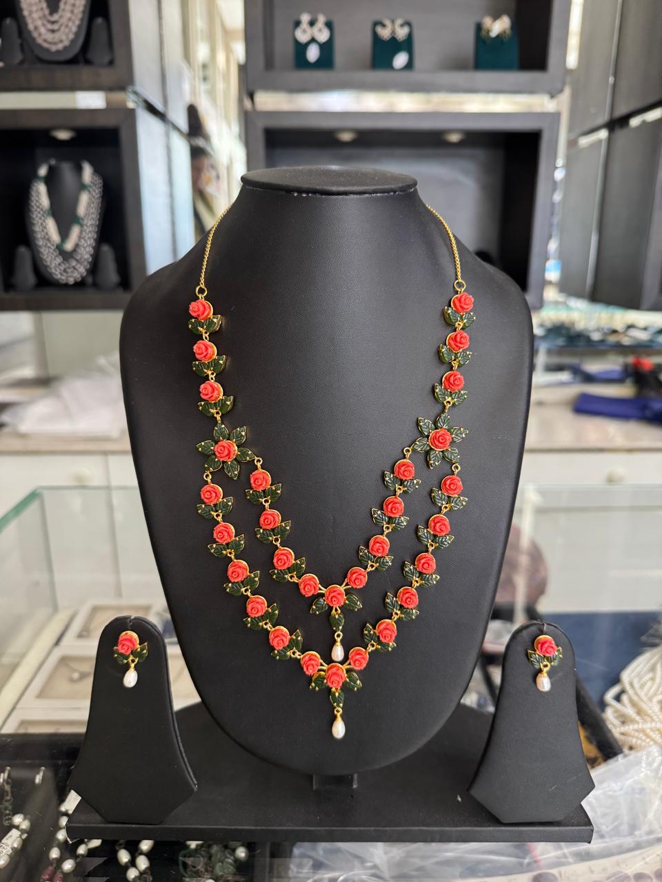 Coral Rose Elegance two line necklace set with hand-carved coral roses and freshwater pearl drops.