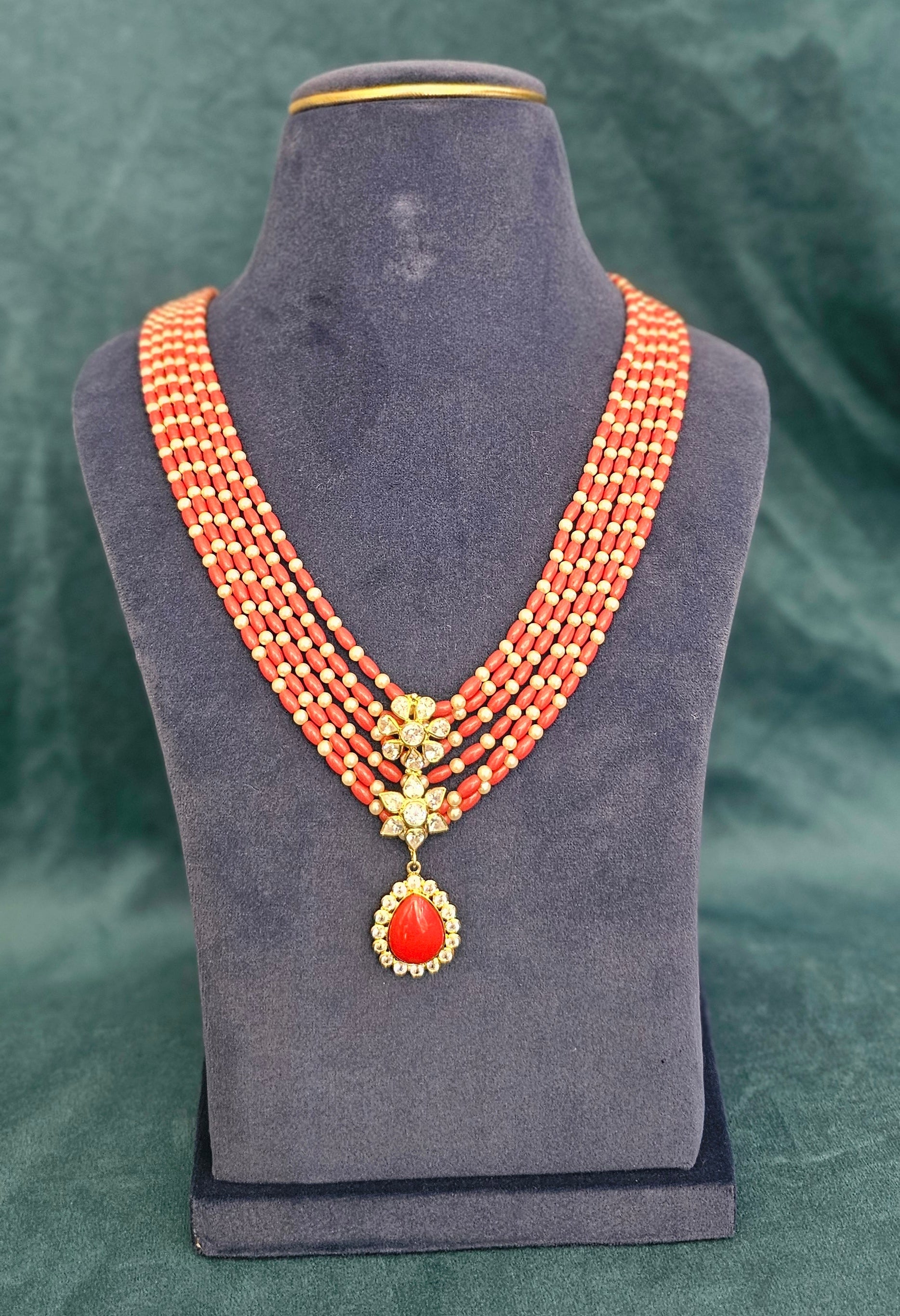 Coral Royale Taiwan coral and Mother of Pearl five layer necklace with floral pendant.