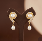 Curved gold tone pearl drop earrings for women