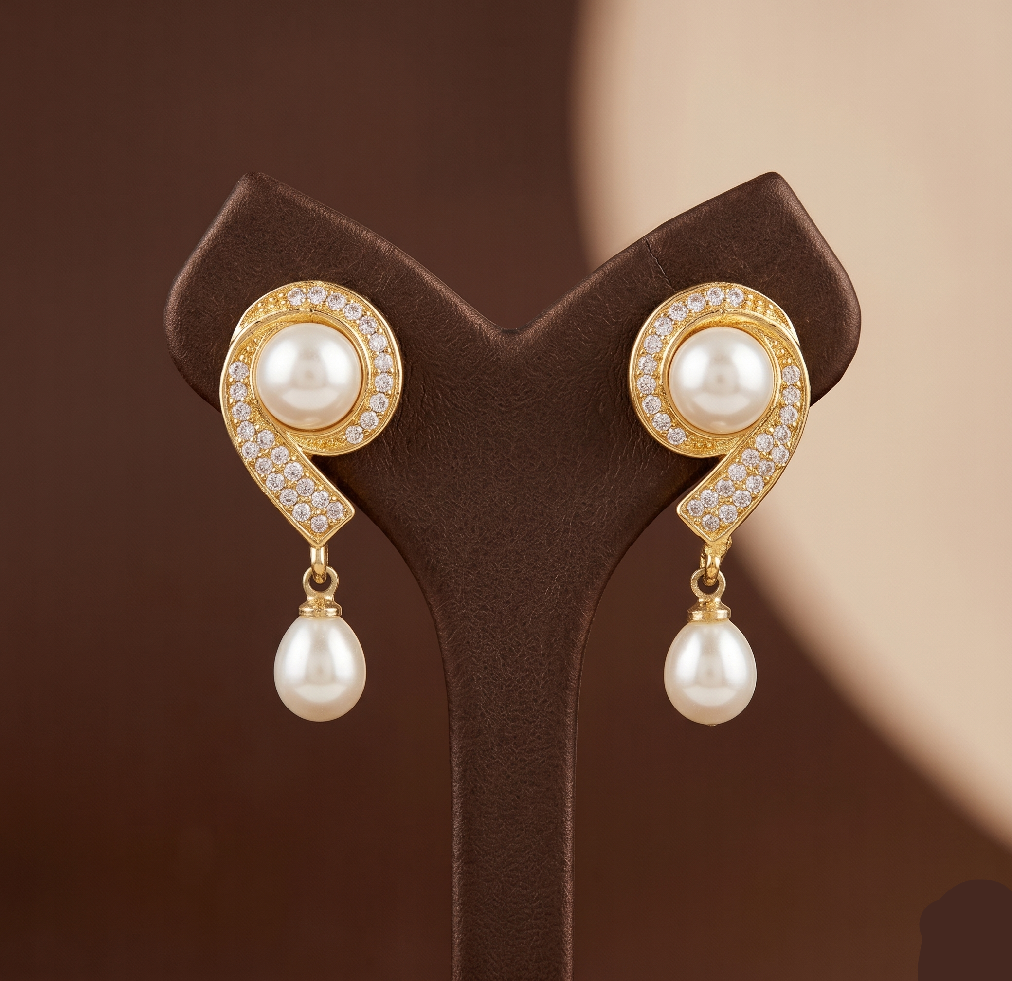 Curved gold tone pearl drop earrings for women