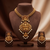 Divine Lakshmi temple necklace set with antique gold finish, peacock motifs, and matching earrings.