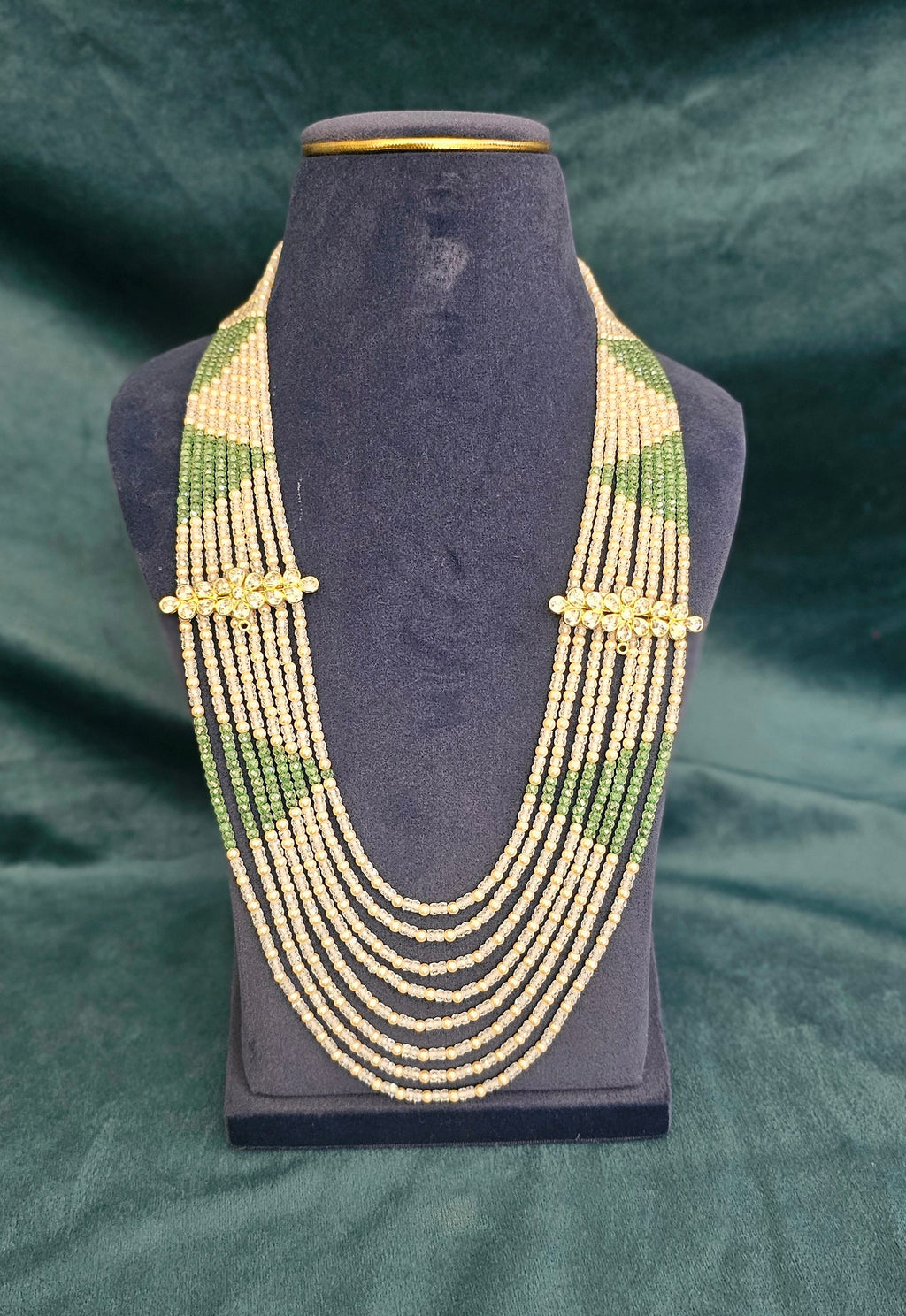 Emerald Royale seven layer fancy pearl necklace with green beads and gold-tone spacers.