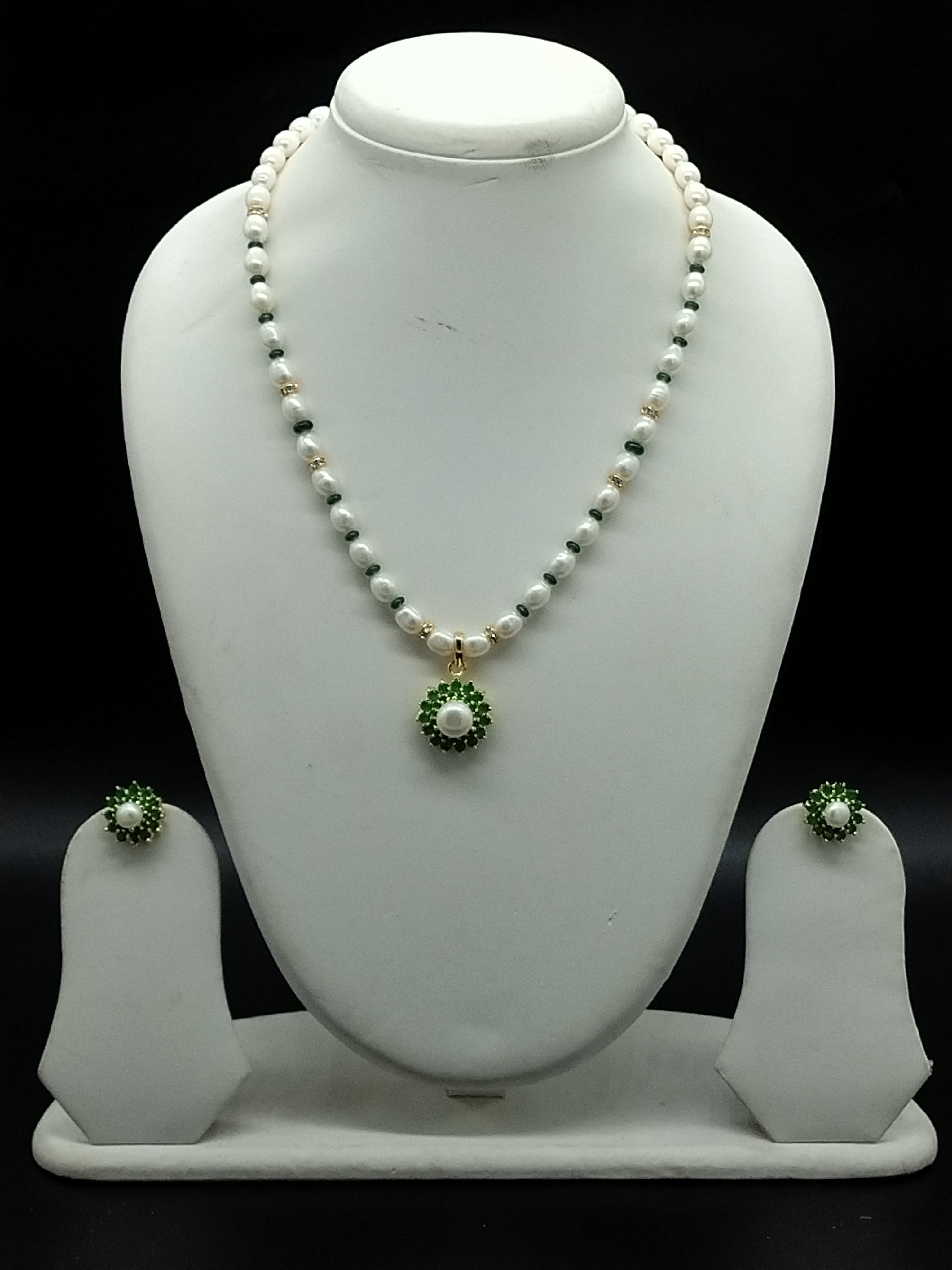 Emerald freshwater pearl pendant necklace set with white oval pearls and green stone halo pendant