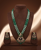 Freshwater pearl and green beads long haram set with peacock pendant and matching earrings.