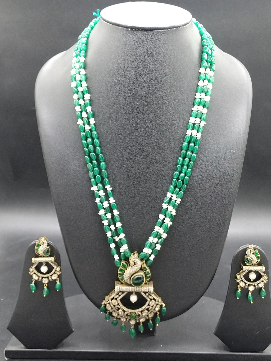 Freshwater pearl and green beads long haram set with peacock pendant and matching earrings.