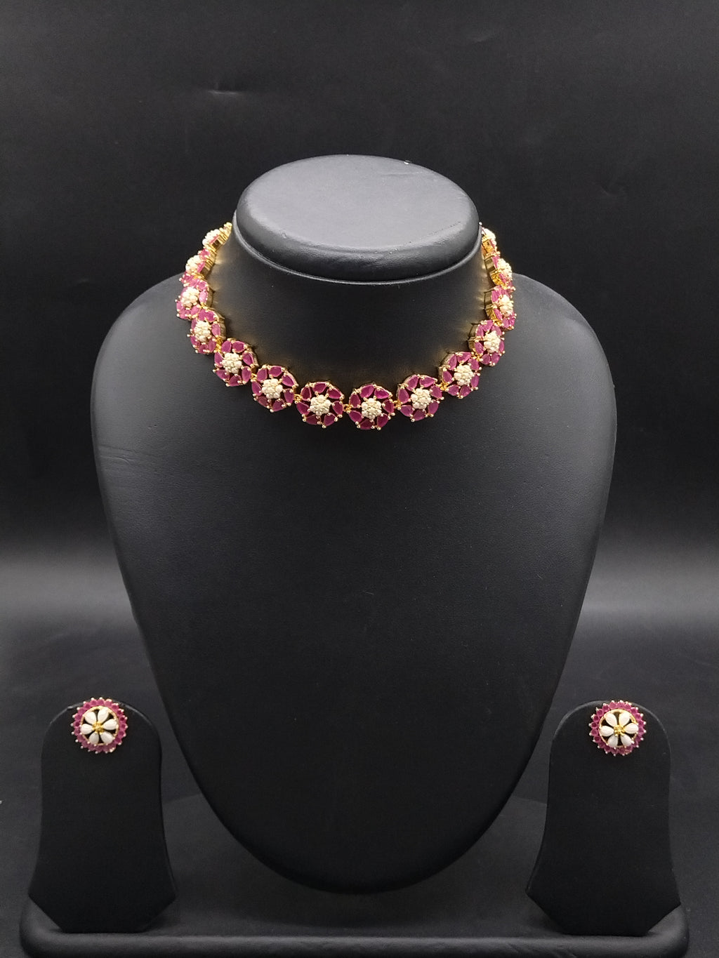 Freshwater pearl choker set with floral red stone motifs, white accents, and matching stud earrings.