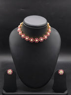 Freshwater pearl choker set with floral red stone motifs, white accents, and matching stud earrings.