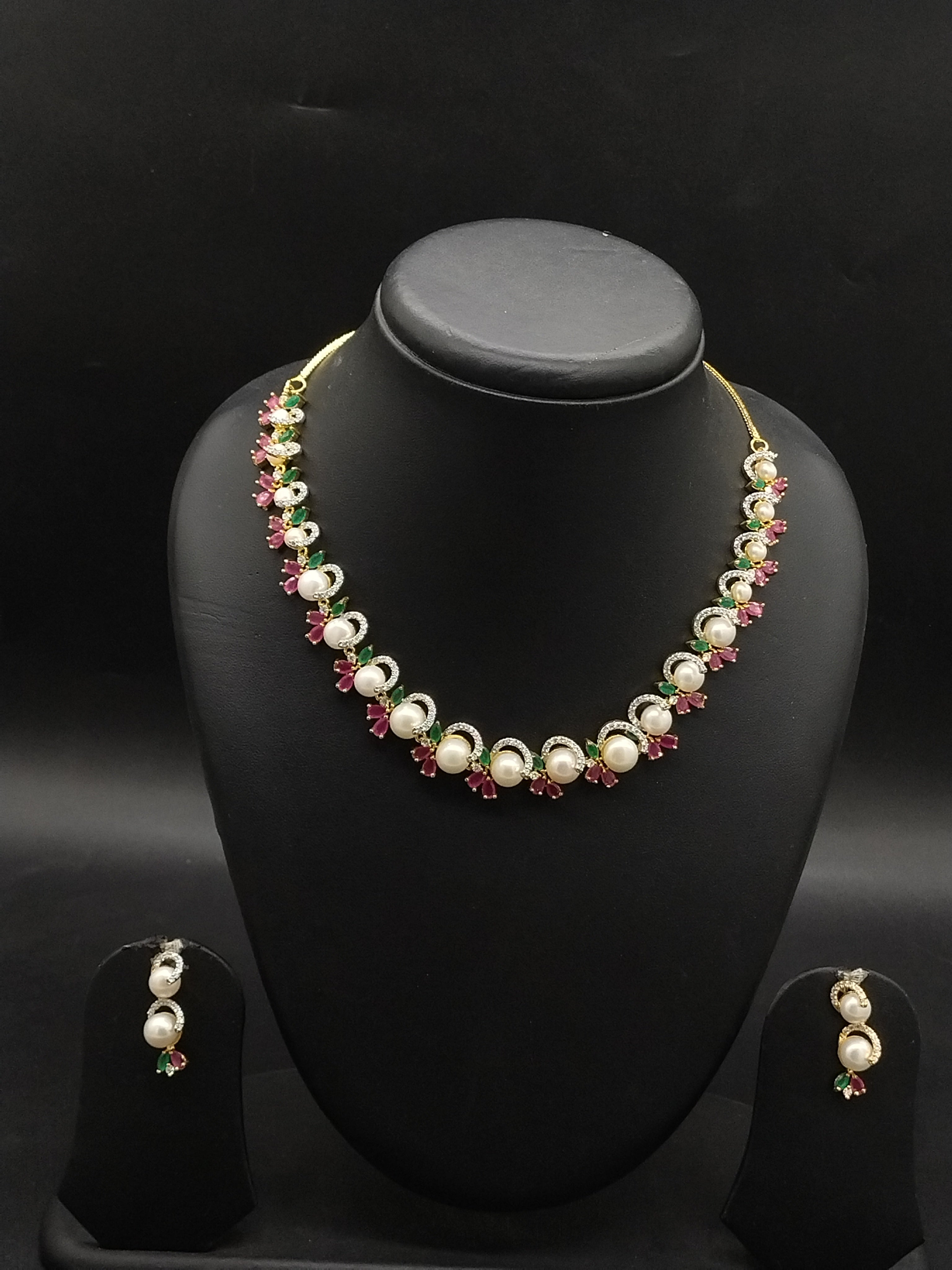 Freshwater pearl choker set with red, green, and white stone floral clusters and matching drop earrings.