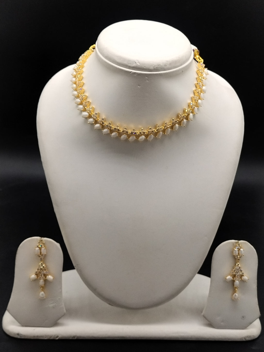 Freshwater pearl choker set with white AD stones, pearl fringe detailing, and matching drop earrings.
