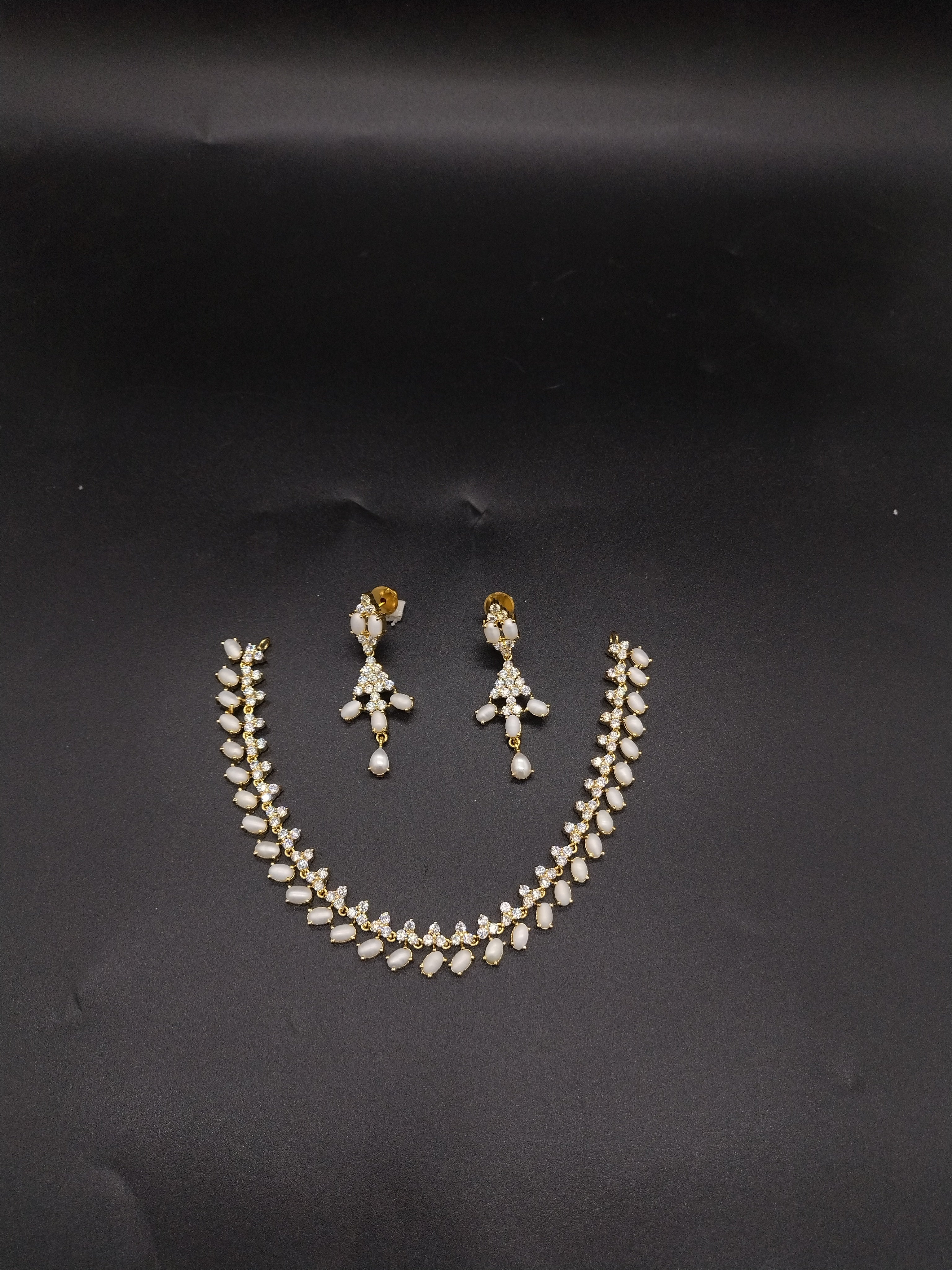 Freshwater pearl choker set with white AD stones, pearl fringe detailing, and matching drop earrings.