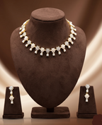 Freshwater pearl choker set with white stone floral motifs and matching earrings.