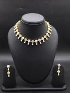 Freshwater pearl choker set with white stone floral motifs and matching earrings.