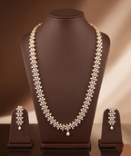 Freshwater pearl long haram set with floral American Diamond motifs and matching earrings.