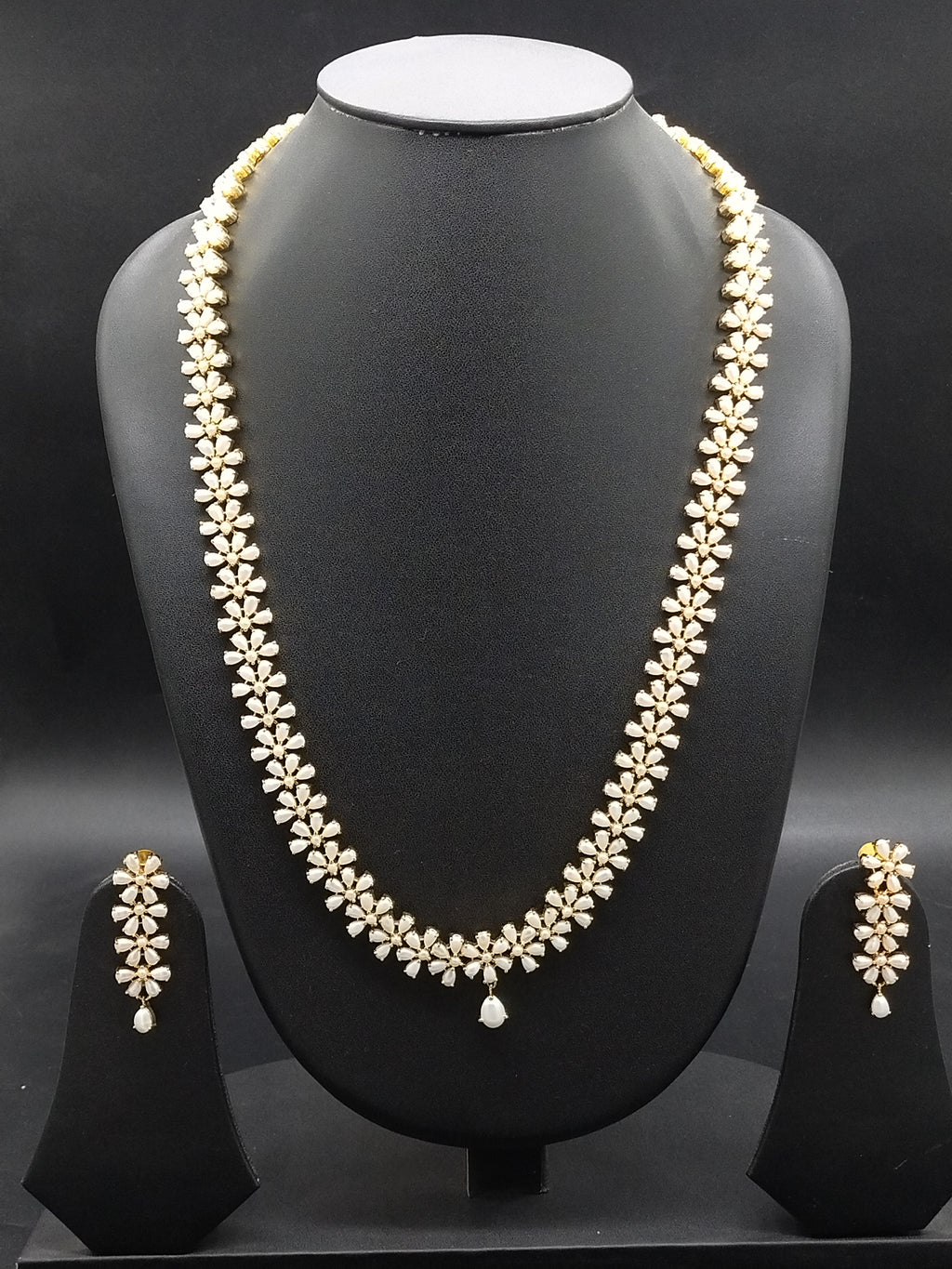 Freshwater pearl long haram set with floral American Diamond motifs and matching earrings.