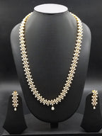 Freshwater pearl long haram set with floral American Diamond motifs and matching earrings.