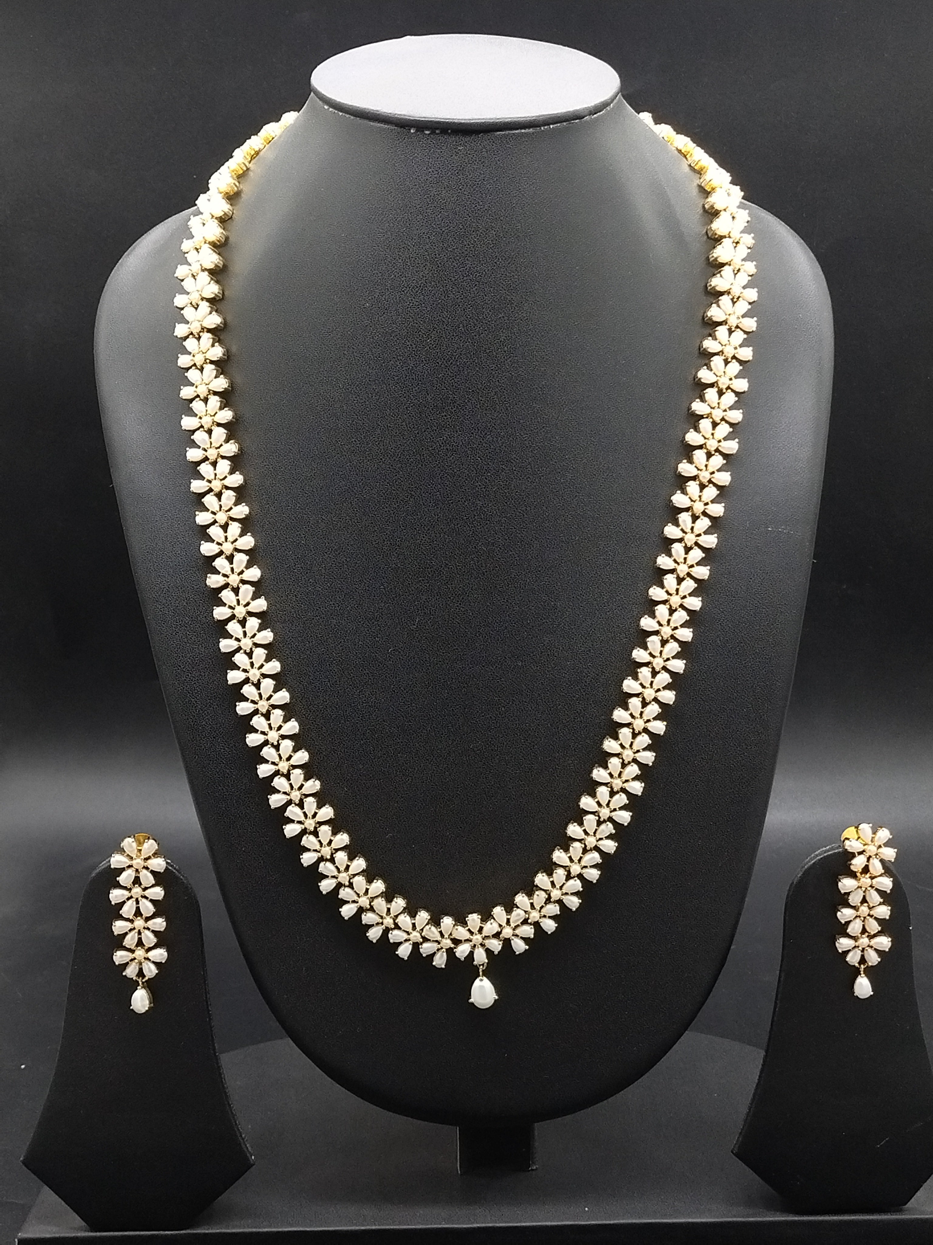 Freshwater pearl long haram set with floral American Diamond motifs and matching earrings.