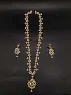 Freshwater pearl long haram set with floral motifs, ornate centerpiece, and matching floral earrings.
