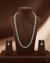 Freshwater pearl long haram set with green and red stone accents and matching drop earrings.
