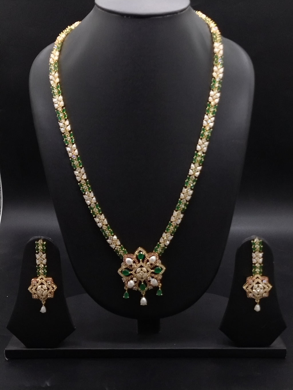 Freshwater pearl long haram set with green, red, and white stone centerpiece and matching earrings.
