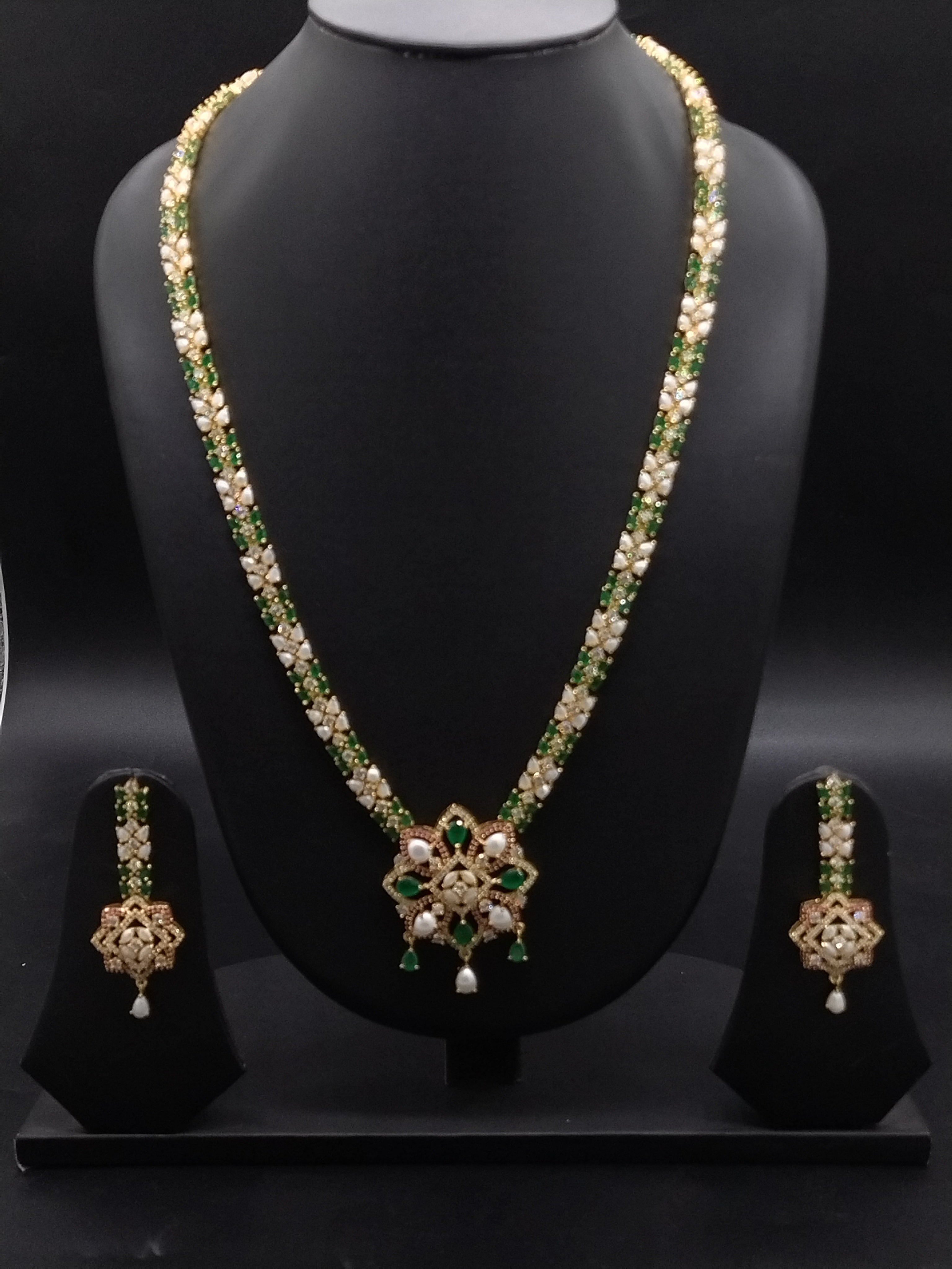 Freshwater pearl long haram set with green, red, and white stone centerpiece and matching earrings.