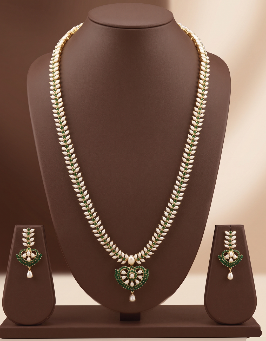 Freshwater pearl long haram set with green stones, floral centerpiece, pearl drop detailing, and matching earrings.
