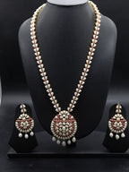 Freshwater pearl long haram set with red and white stone floral motifs, circular pendant with pearl drops, and matching earrings.