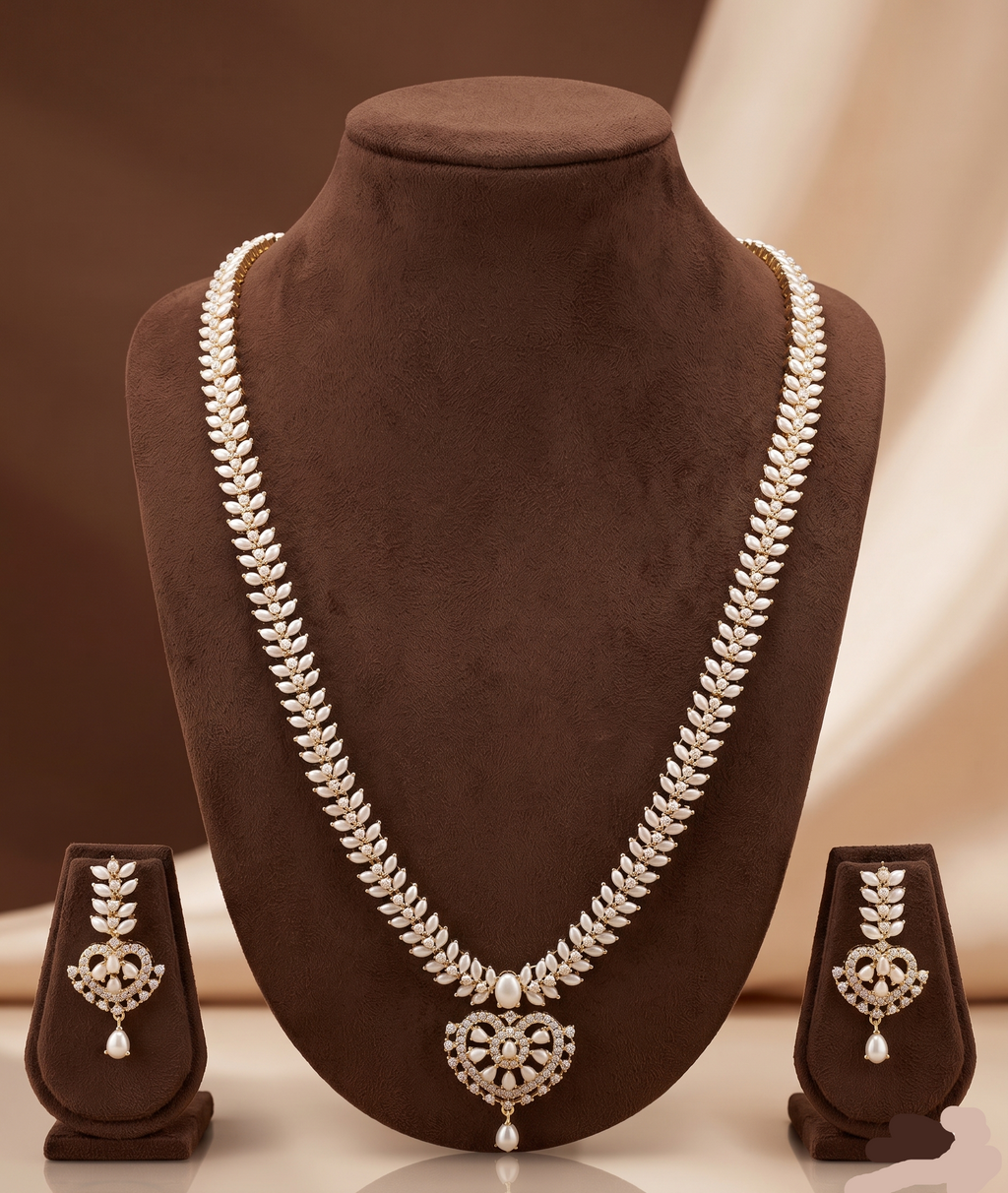 Freshwater pearl long haram set with white AD stones, ornate medallion pendant, pearl drop detailing, and matching earrings.