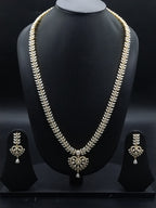 Freshwater pearl long haram set with white AD stones, ornate medallion pendant, pearl drop detailing, and matching earrings.