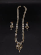 Freshwater pearl long haram set with white AD stones, ornate medallion pendant, pearl drop detailing, and matching earrings.