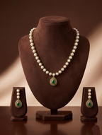 Freshwater pearl necklace set with emerald green teardrop pendant and matching drop earrings