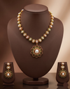 Freshwater pearl necklace set with floral red and green stone pendant and matching earrings.