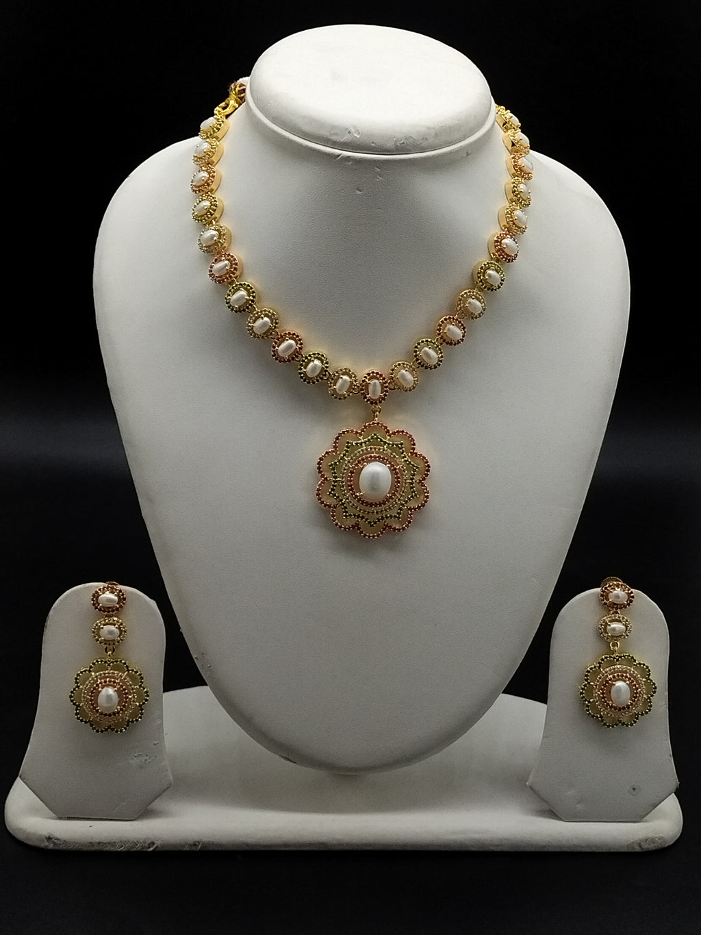 Freshwater pearl necklace set with floral red and green stone pendant and matching earrings.