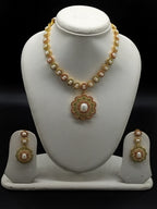 Freshwater pearl necklace set with floral red and green stone pendant and matching earrings.