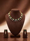 Freshwater pearl necklace set with green stones, floral motifs, pearl clusters, teardrop pearl drops, and matching earrings.
