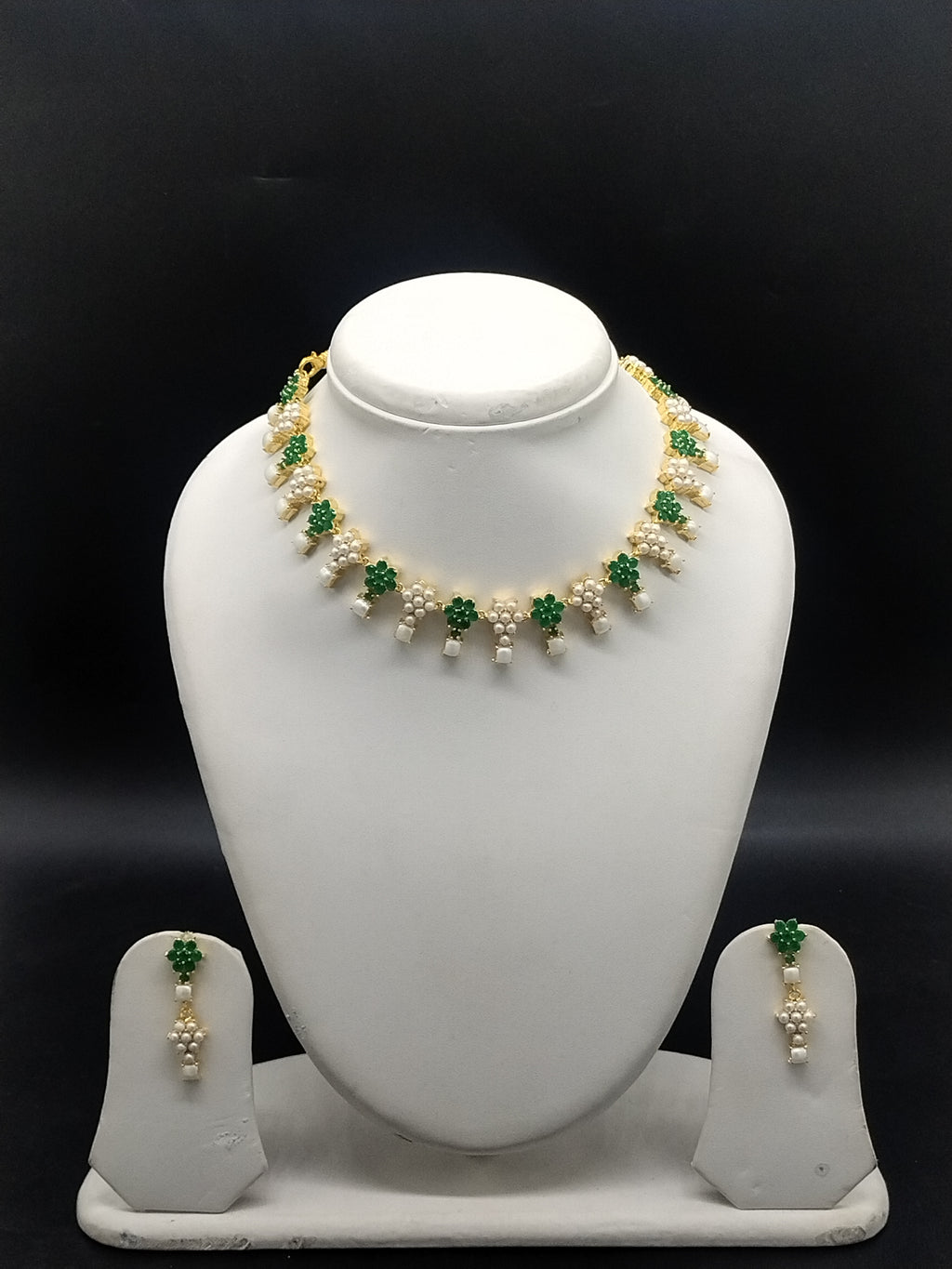Freshwater pearl necklace set with green stones, floral motifs, pearl clusters, teardrop pearl drops, and matching earrings.