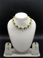 Freshwater pearl necklace set with green stones, floral motifs, pearl clusters, teardrop pearl drops, and matching earrings.