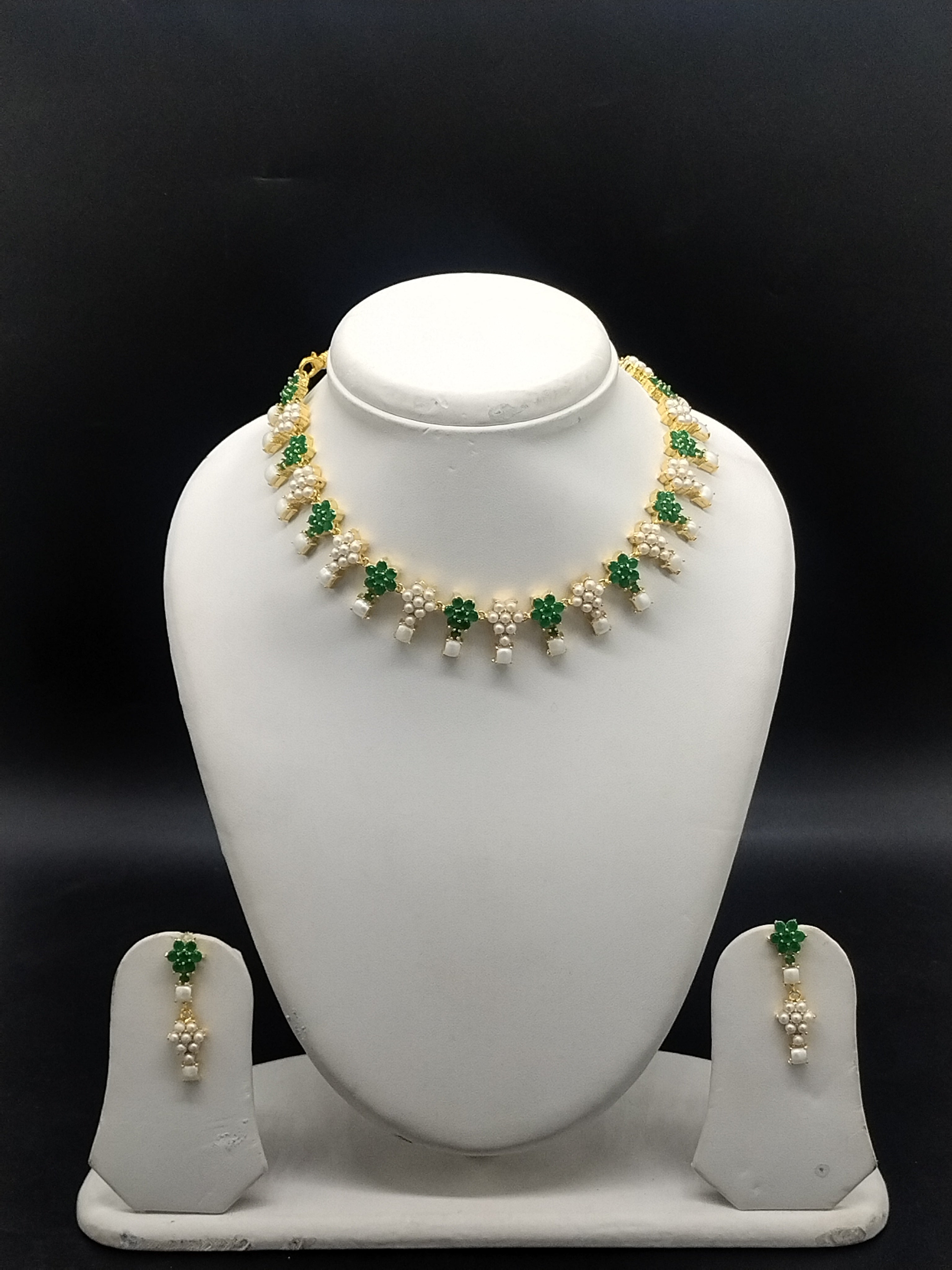 Freshwater pearl necklace set with green stones, floral motifs, pearl clusters, teardrop pearl drops, and matching earrings.