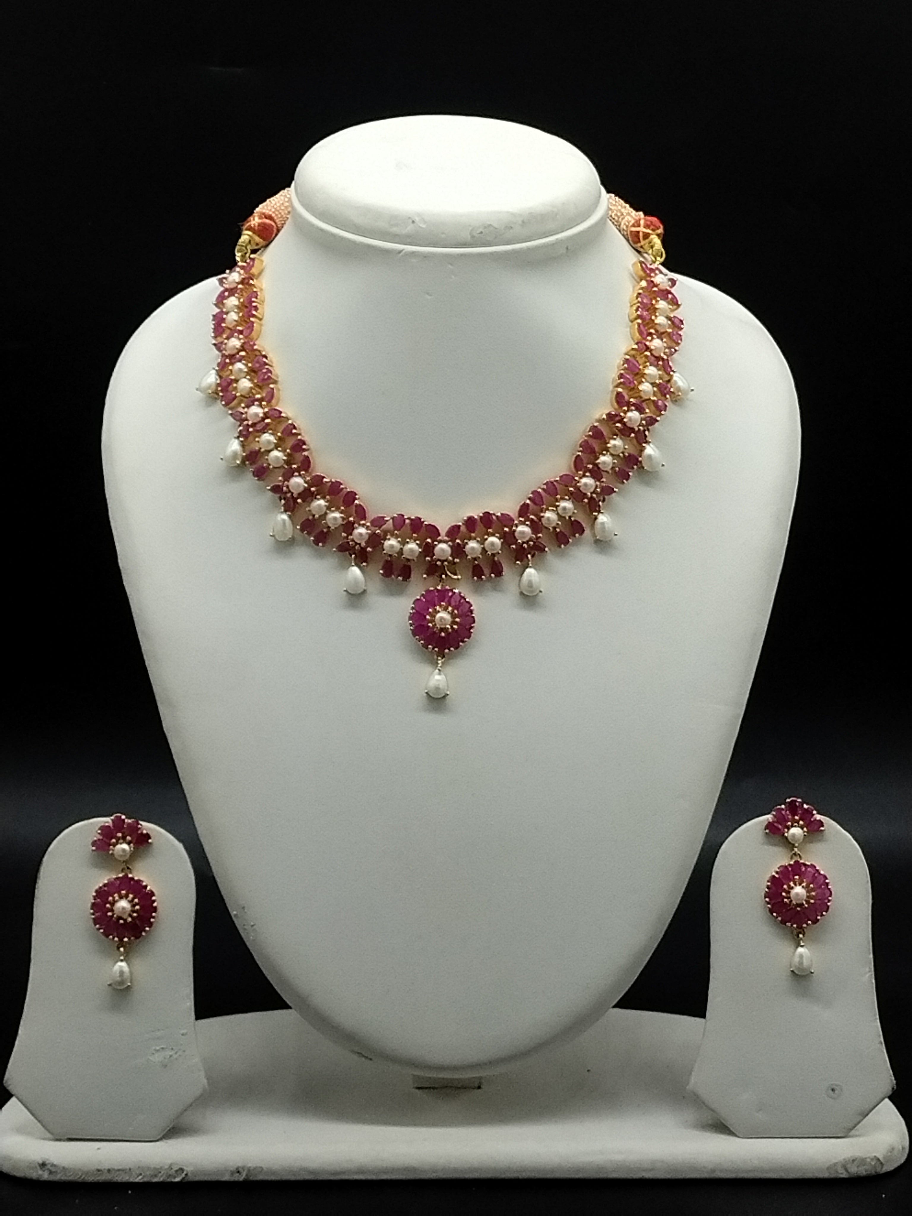Freshwater pearl necklace set with red stone floral centerpiece, pearl drop detailing, and matching earrings.