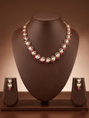 Freshwater pearl necklace set with ruby red stones, white American Diamond accents, and matching drop earrings.