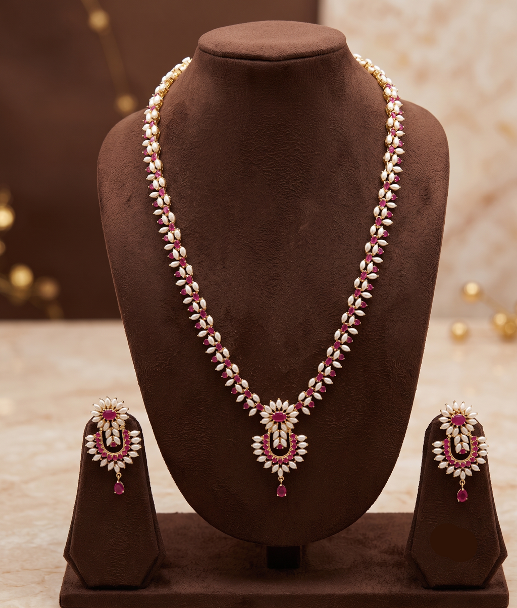 The Crimson Chevron: Rice Pearl Long Haar with Ruby Chandbali Pendant Set
